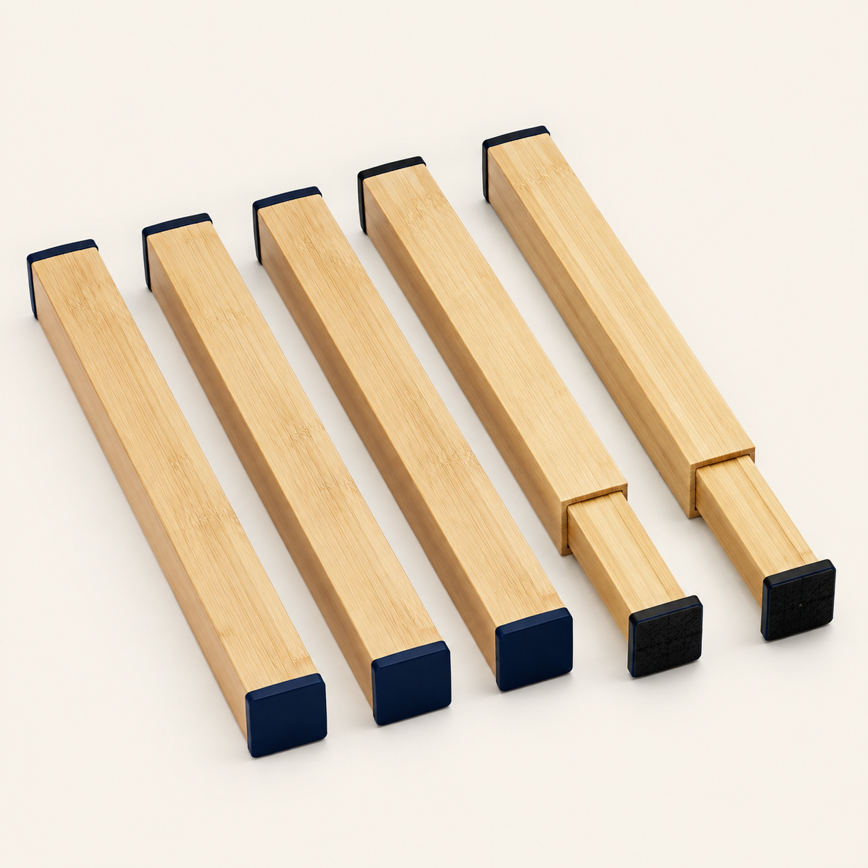 Five adjustable bamboo drawer dividers with navy grips